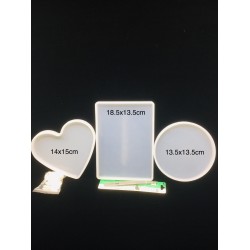Three silicone heart molds and a round and rectangular coaster with tweezers and a finger cap lid